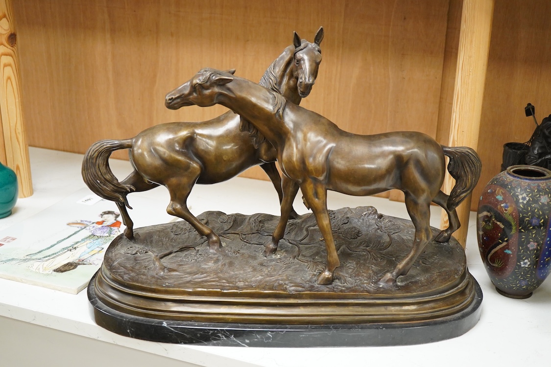 After Pierre-Jules Mêne (1810-1879), a large animalier bronze of two horses, raised on shaped base, 55cm wide